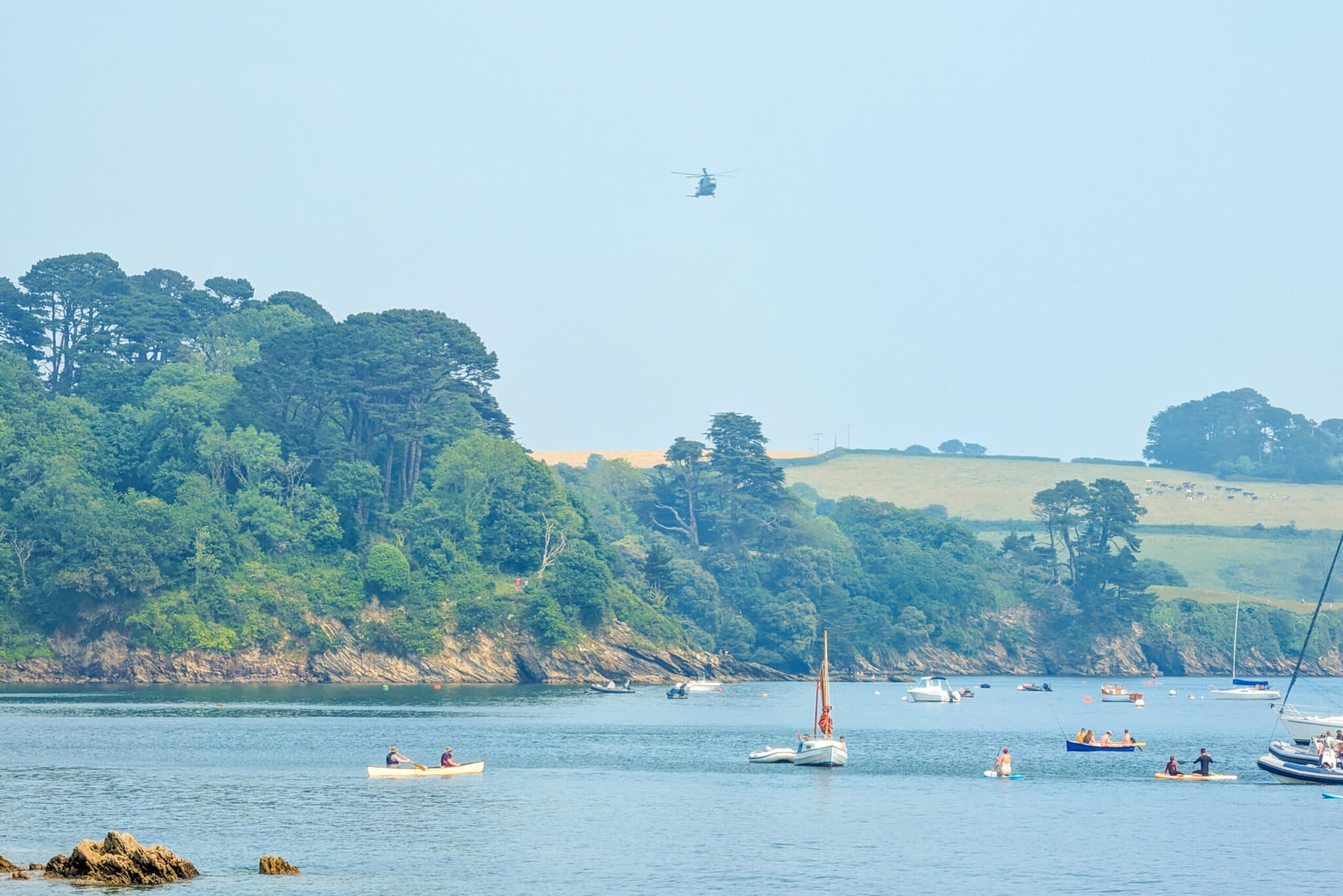 Culdrose helicopter arrives at Trebah Beach to lay a wreath in the sea