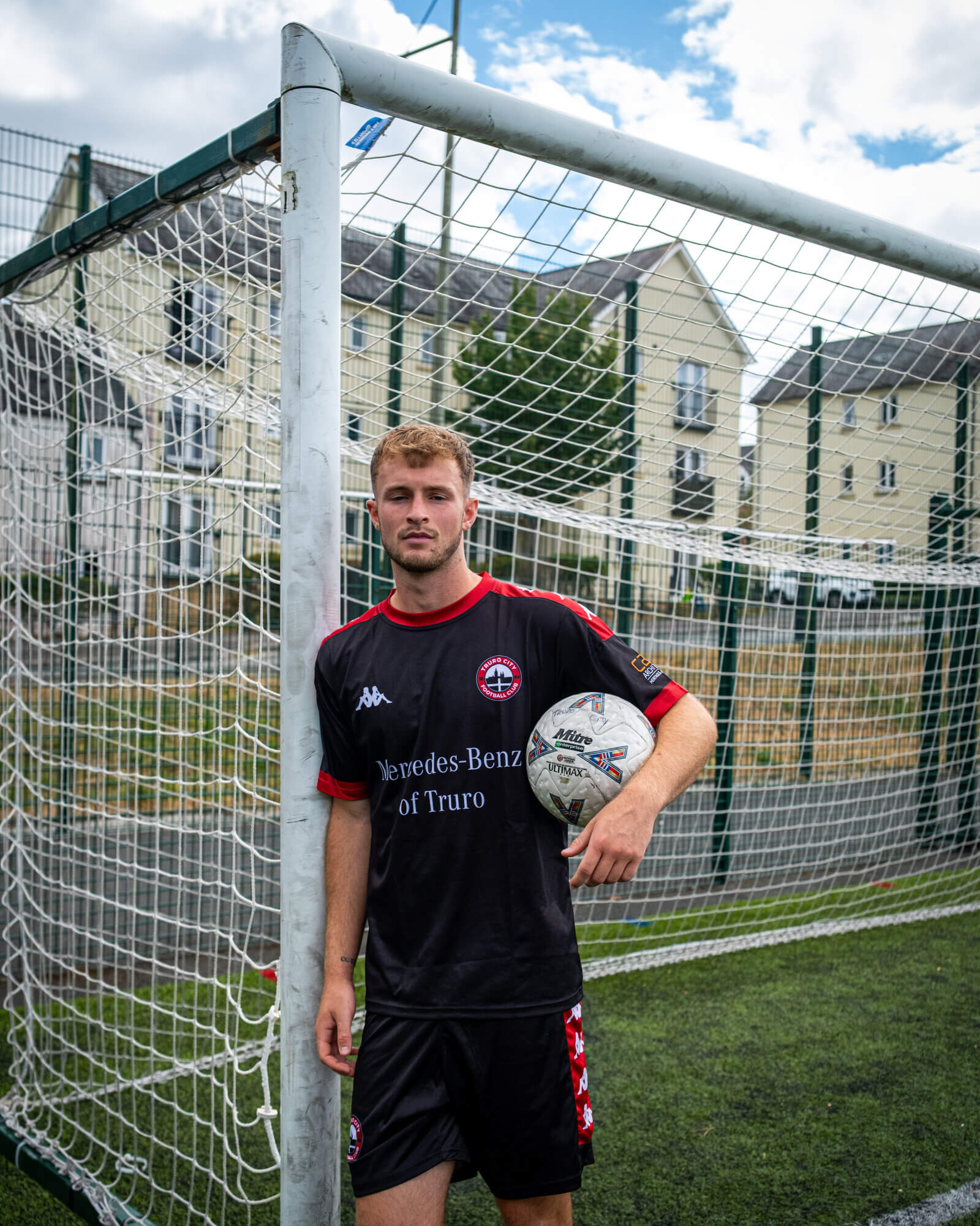 Max Kinsey in Truro City training kit leaning on a goalpost with a ball under his arm