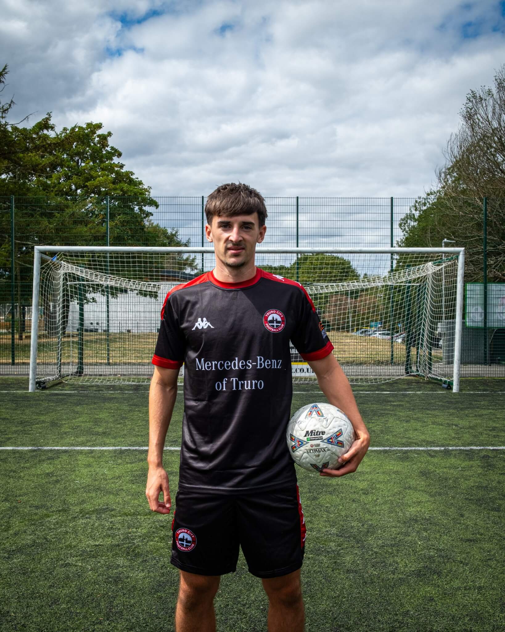 Tom Dean with a matchball wearing the Truro City black training kit