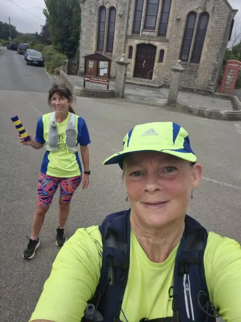Two Carn Runners taking a selfie in front of a Cornish chapel