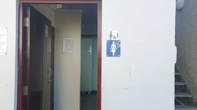 Entrance to the Guildhall public toilets in Looe, with women's and baby-change signs