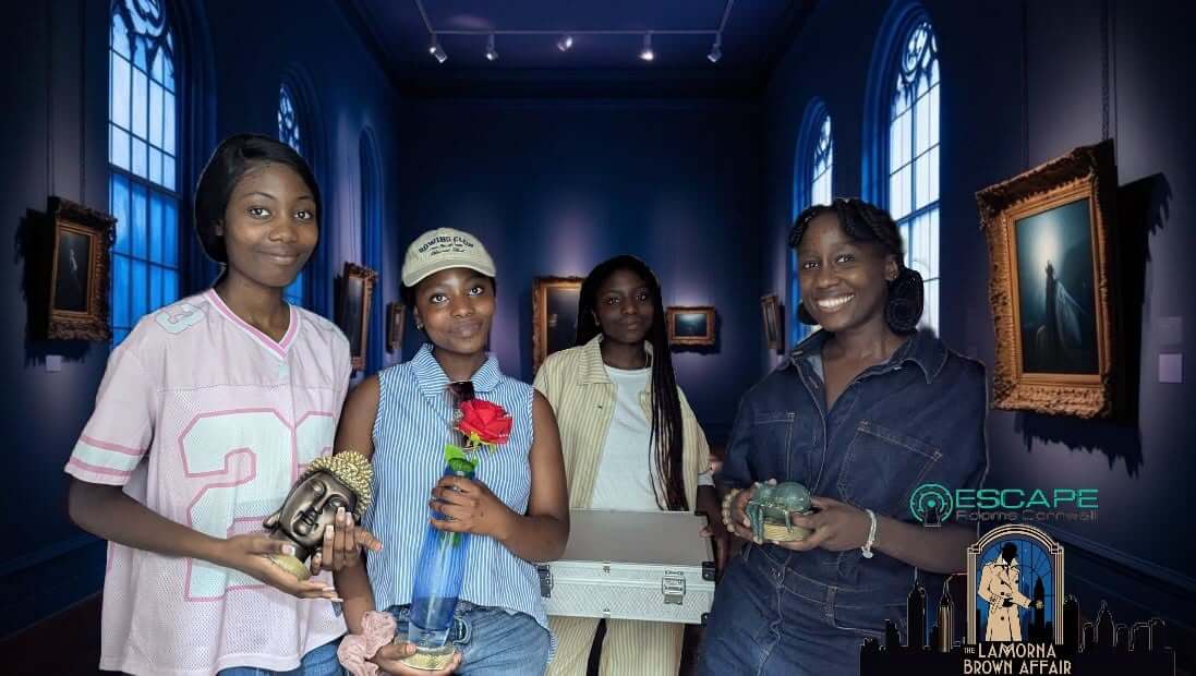 Four players in the Lamorna Brown Affair art gallery room at Escape Rooms Cornwall