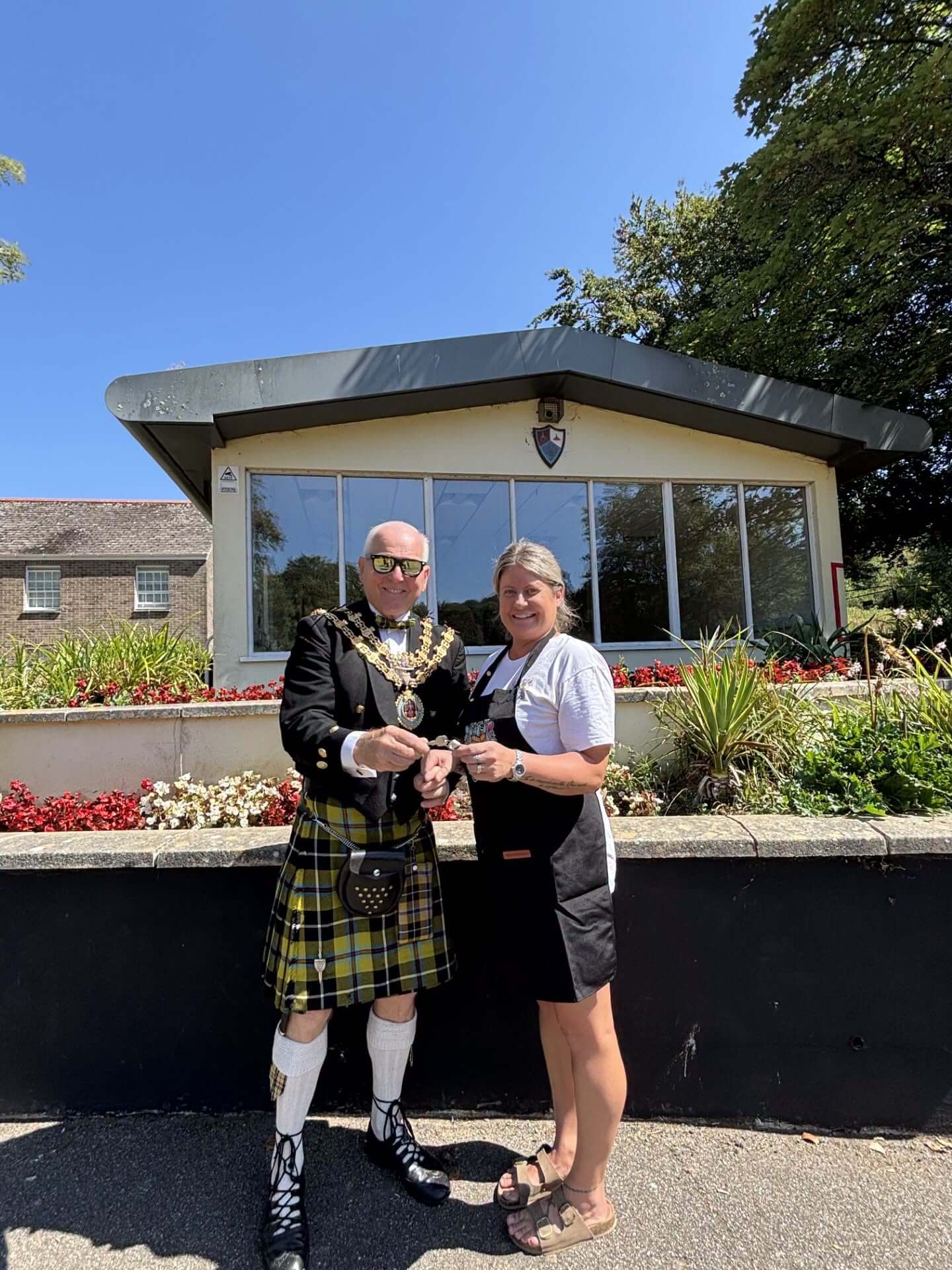 The Mayor of Bodmin hands the keys to Narisa Hall to the owner of Cammy's Little Castles outside the building at Priory Park