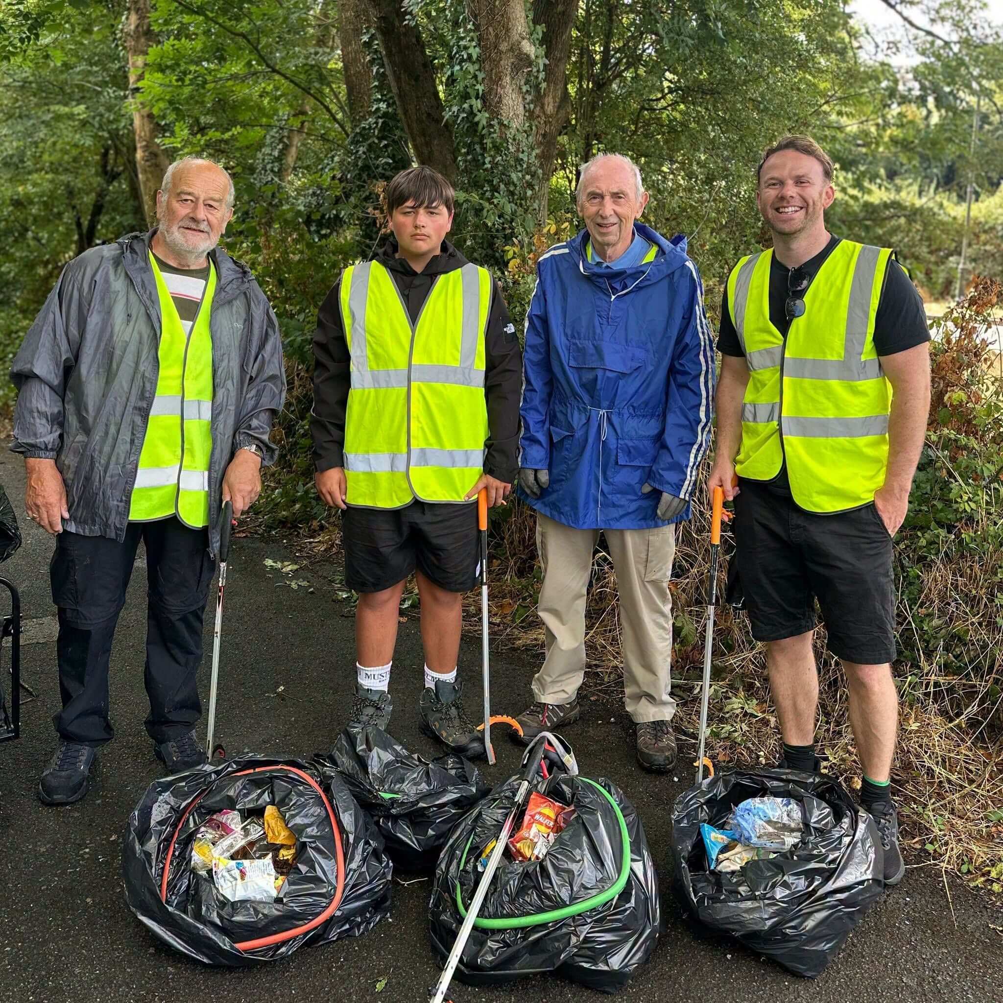 Four Bodmin litter pick volunteers with bags of collected rubbish