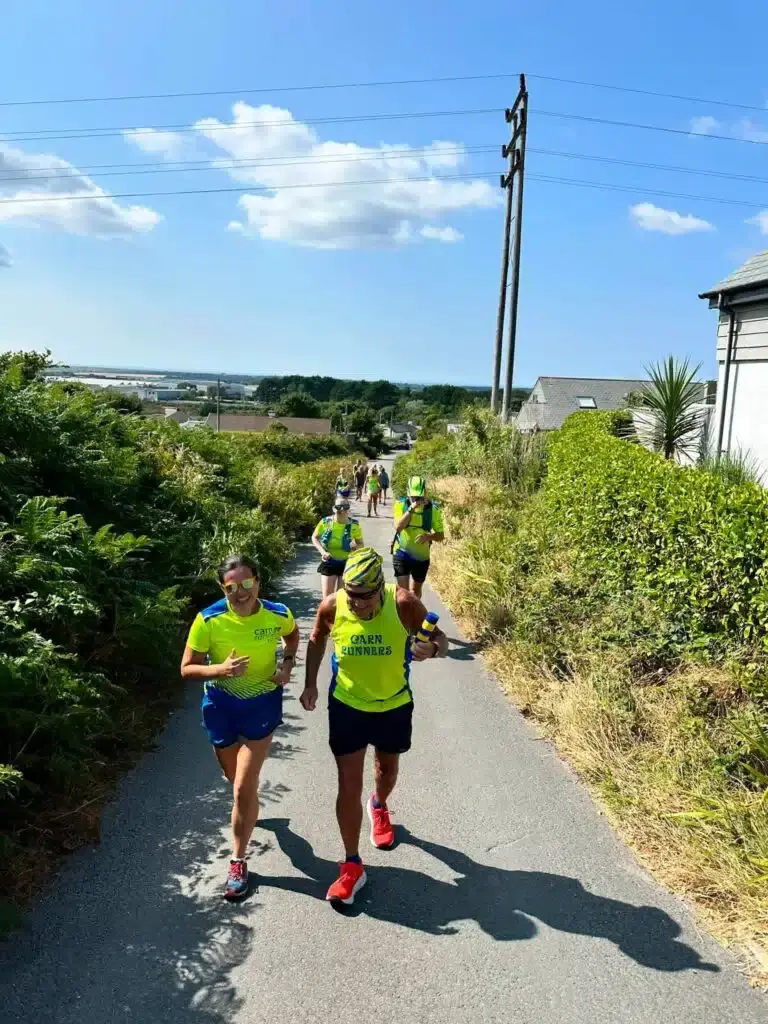 Two Carn Runners running down a lane with others following behind