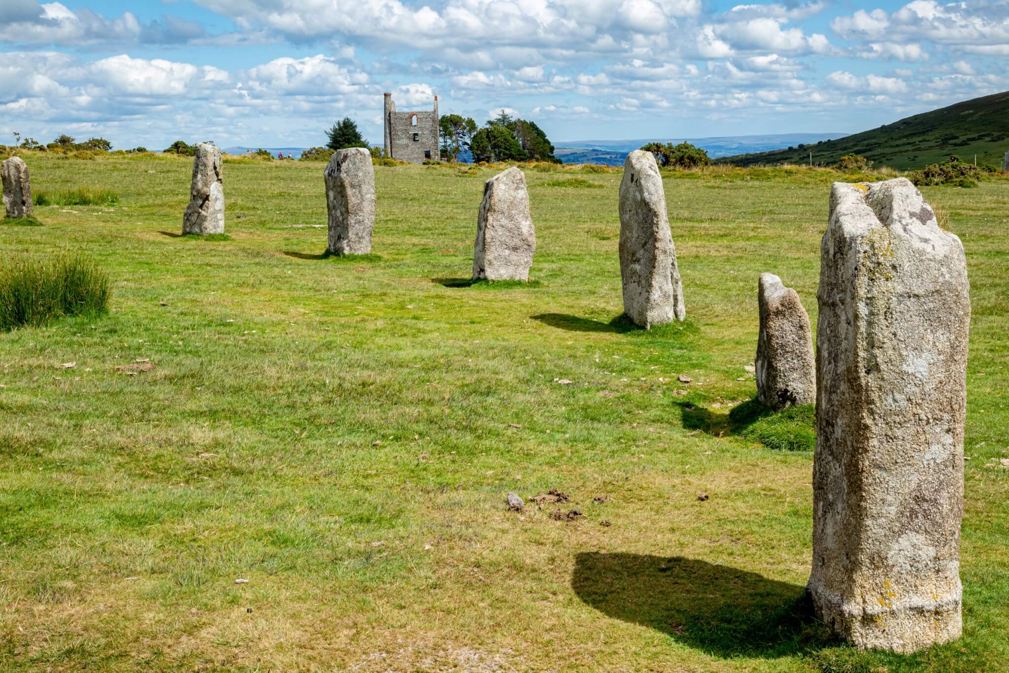 The Hurlers stone circles at Minions on Bodmin Moor, with a ruined mine engine house behind