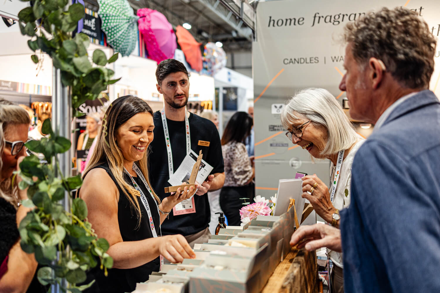 Exhibitors and buyers at a home fragrance stand