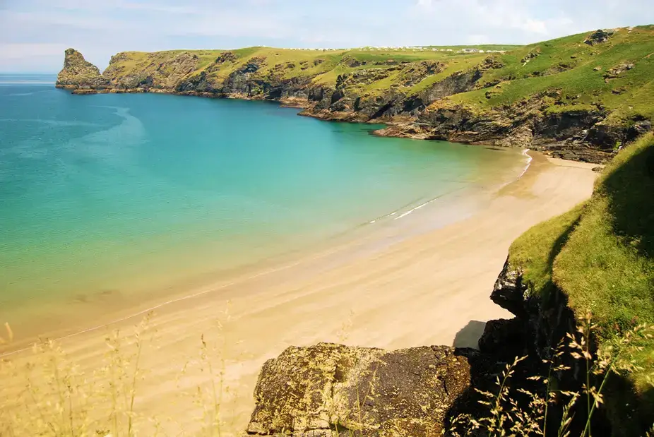 The sandy cove and turquoise water at Bossiney Haven near Tintagel
