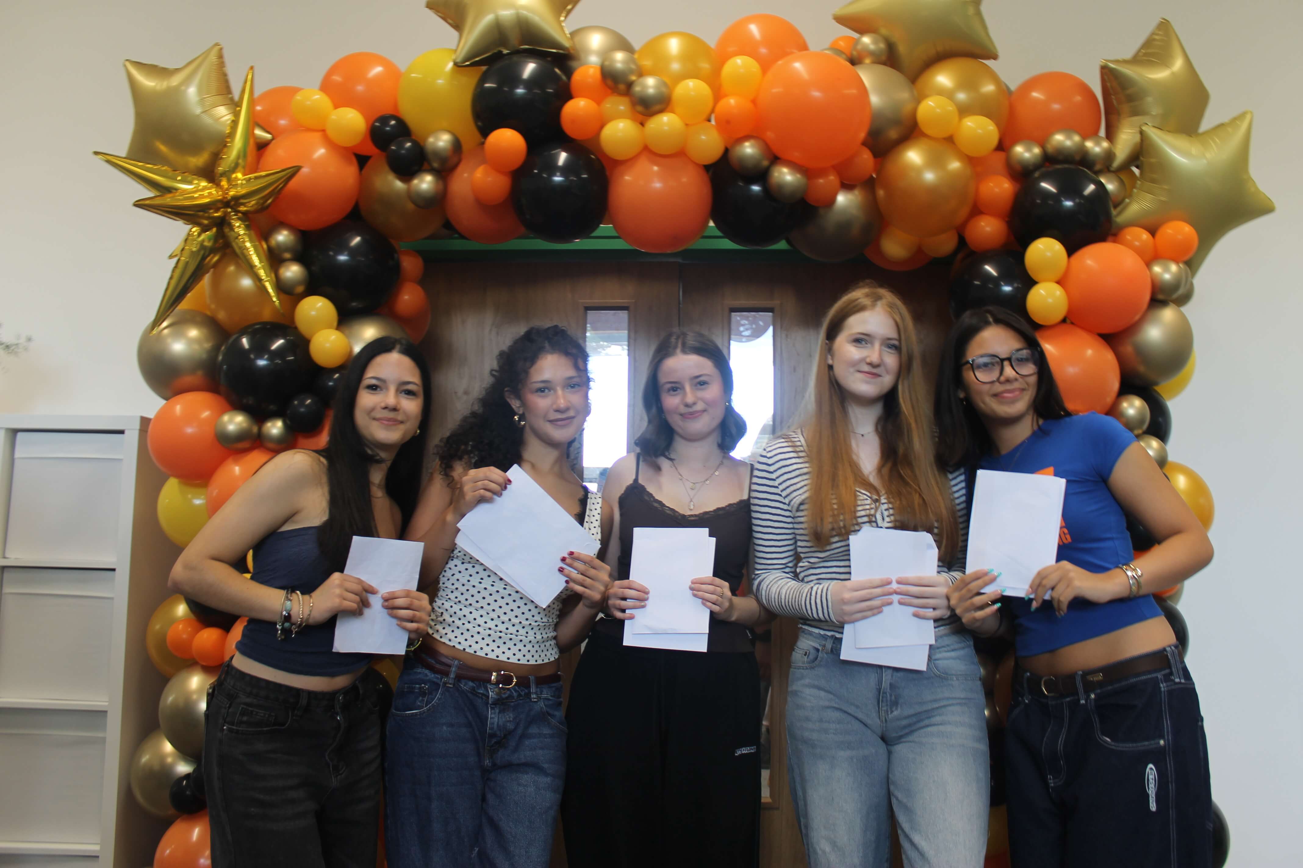 Students holding GCSE results envelopes at Bodmin College