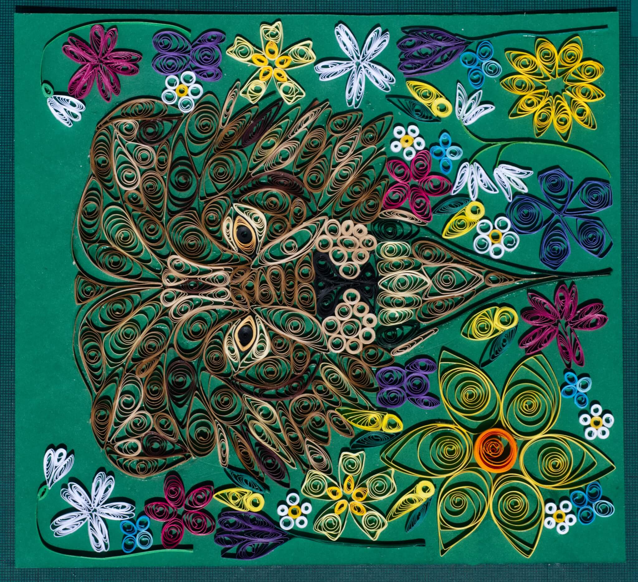 In Like a Lion, a coloured paper quilling artwork of a lion's face surrounded by flowers