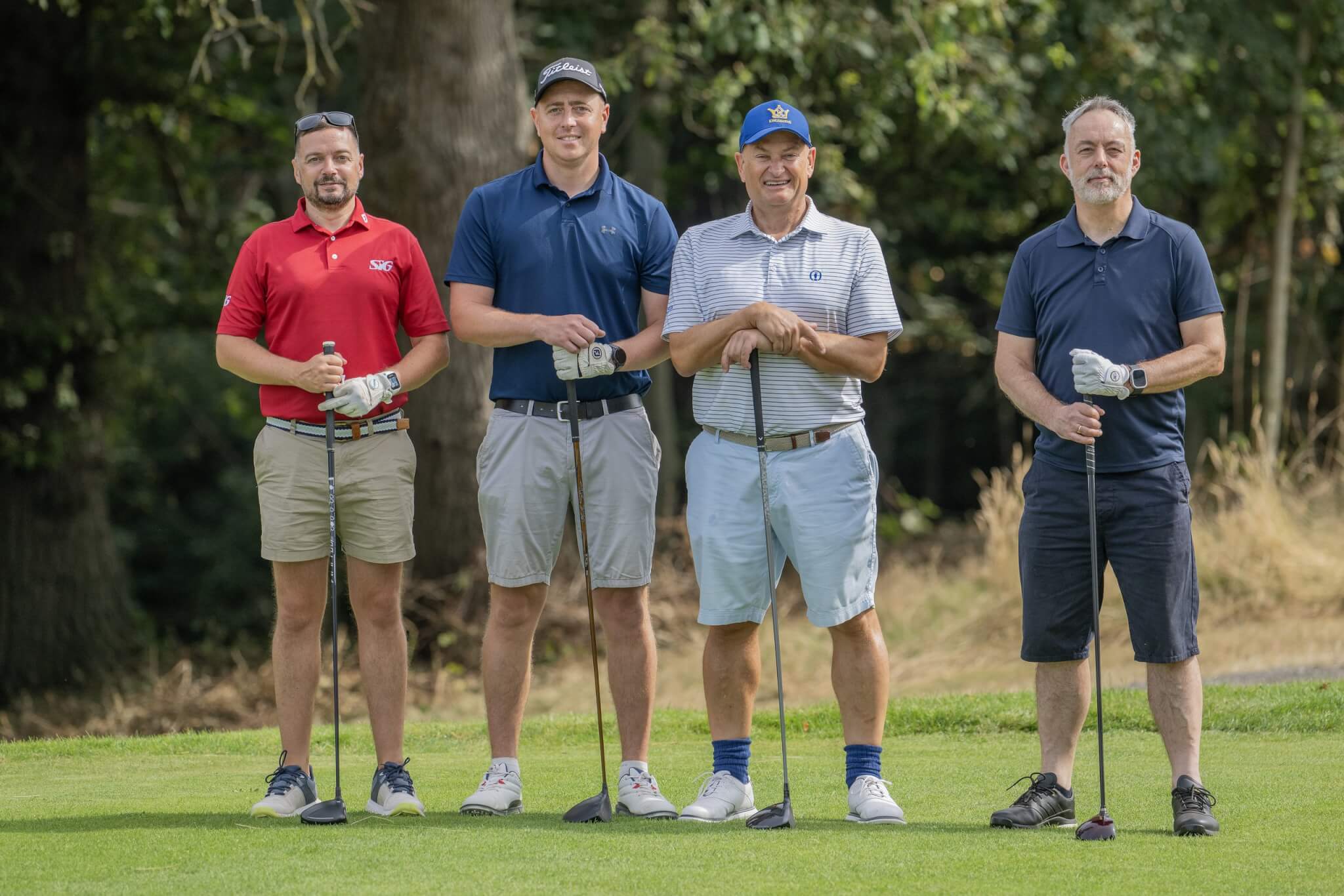 Four golfers with clubs at the Barratt Bristol charity golf day for Children's Hospice South West