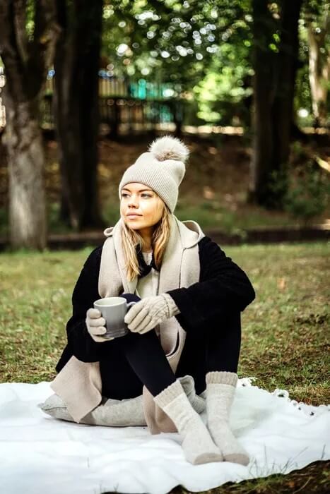 Woman wearing Jess and Lou hat and accessories in a park