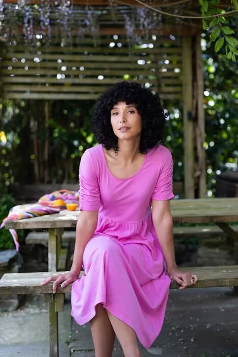 Woman in Nomads clothing sitting at a picnic table