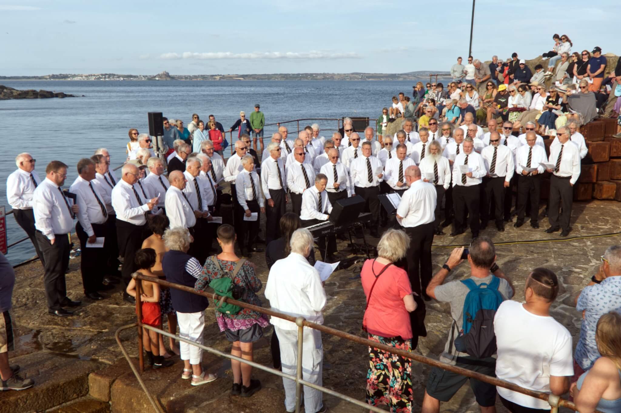 Mousehole Male Voice Choir performing on the harbourside