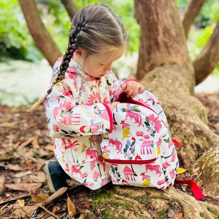 Child in Powell Craft raincoat with matching backpack