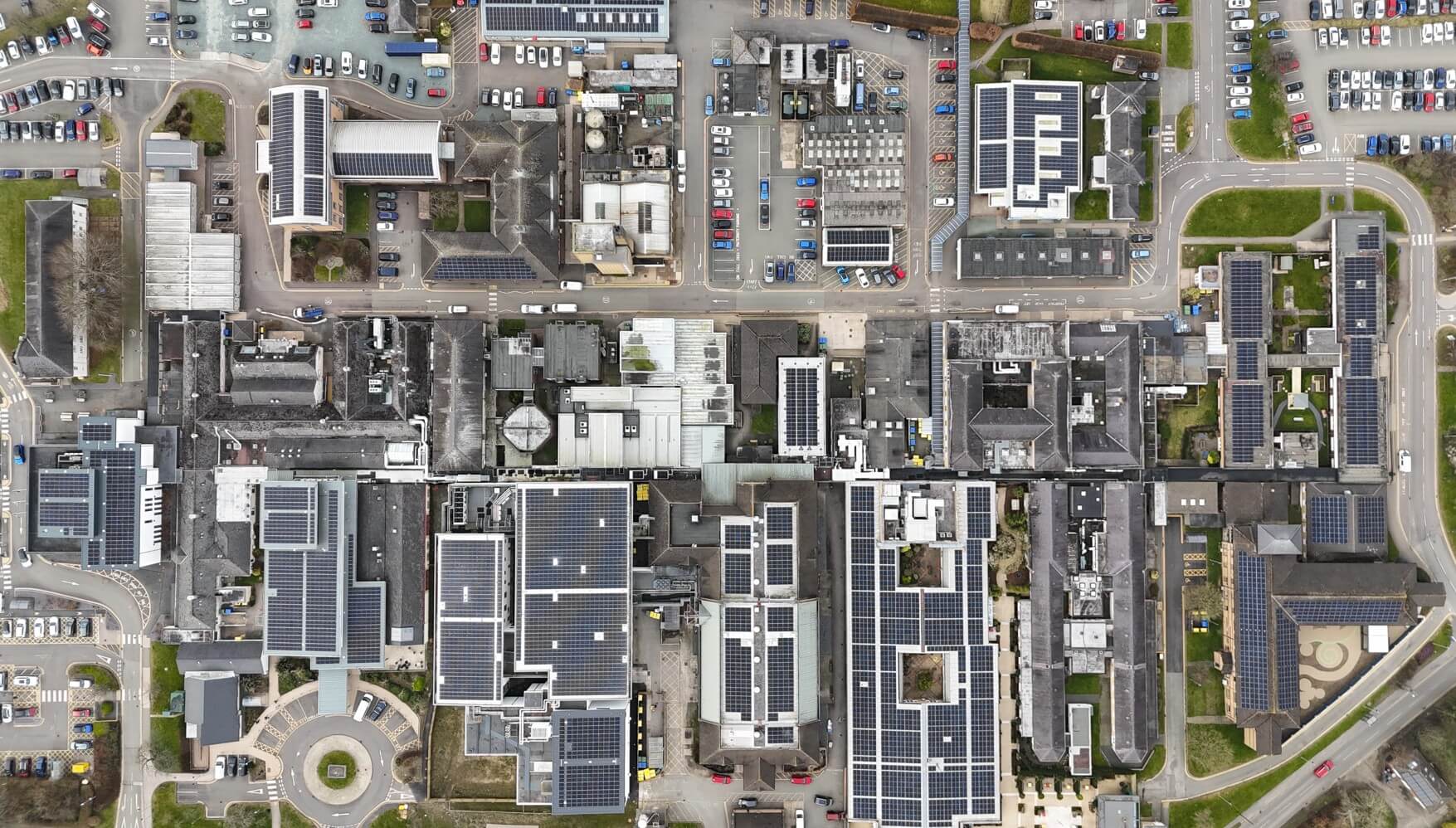 Close aerial view of solar panels installed on hospital rooftops