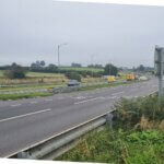 The A30 dual carriageway near Launceston with National Highways maintenance vehicles at the roadside