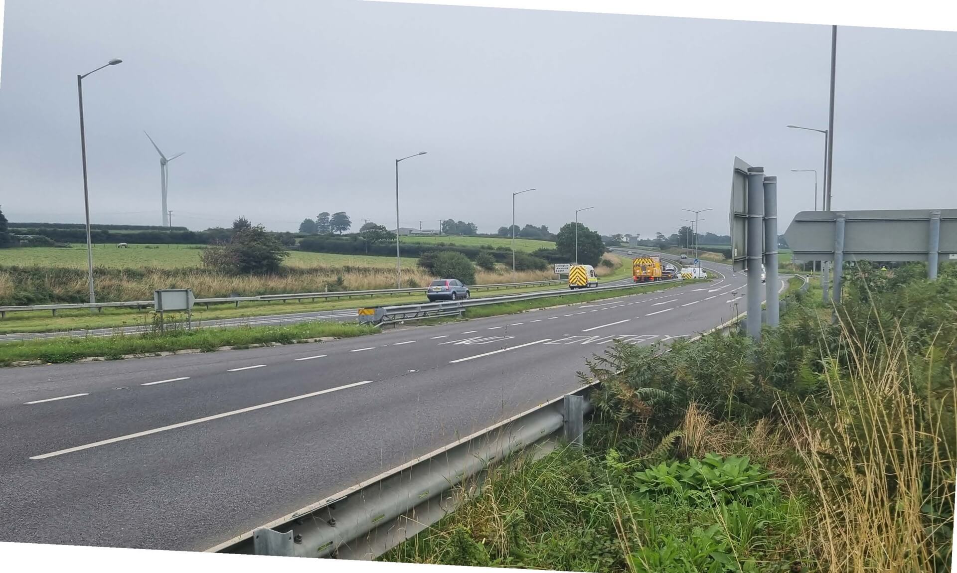 The A30 dual carriageway near Launceston with National Highways maintenance vehicles at the roadside