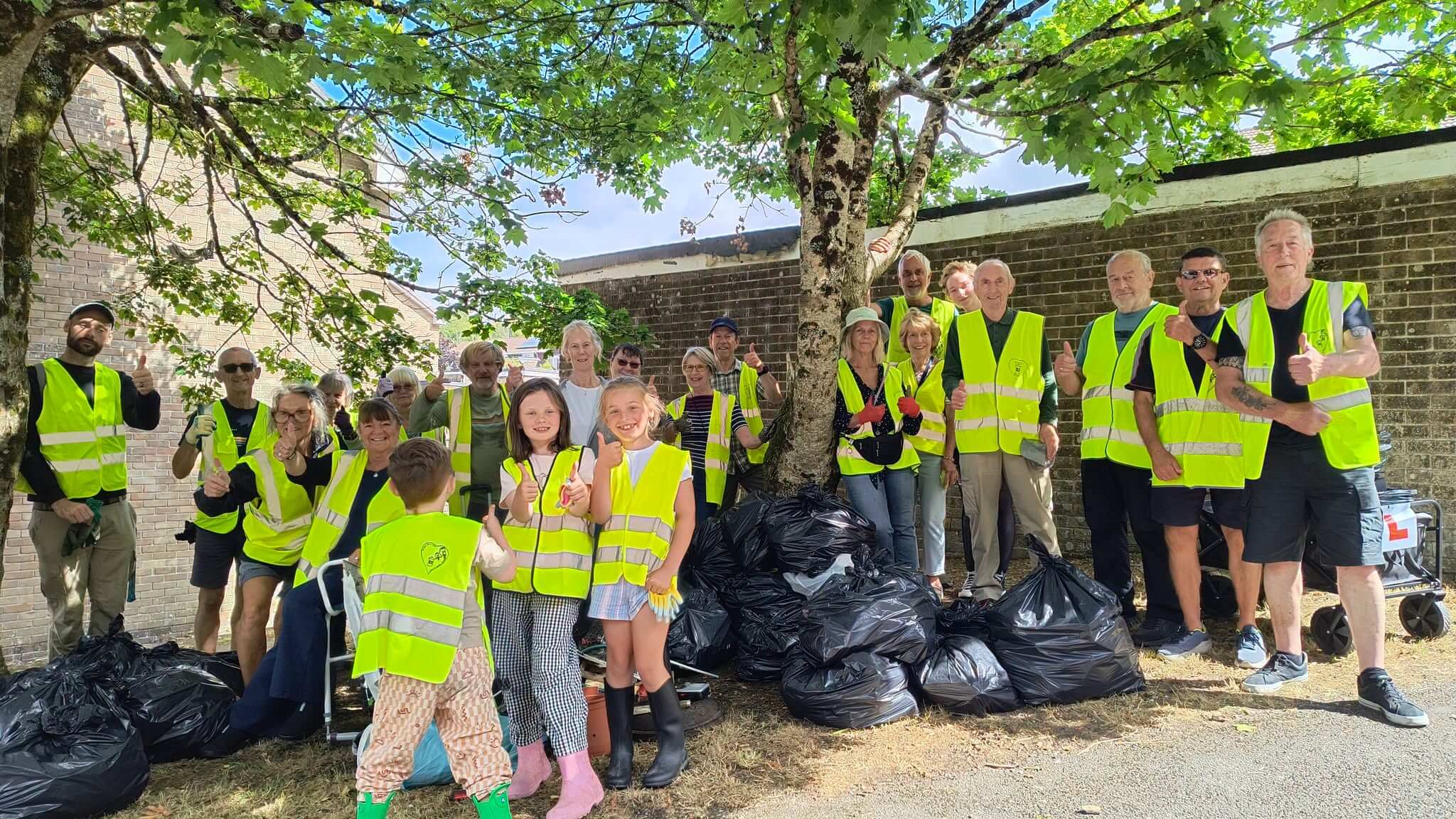 The Bodmin Tidy it Team volunteers give a thumbs up beside their haul of bin bags
