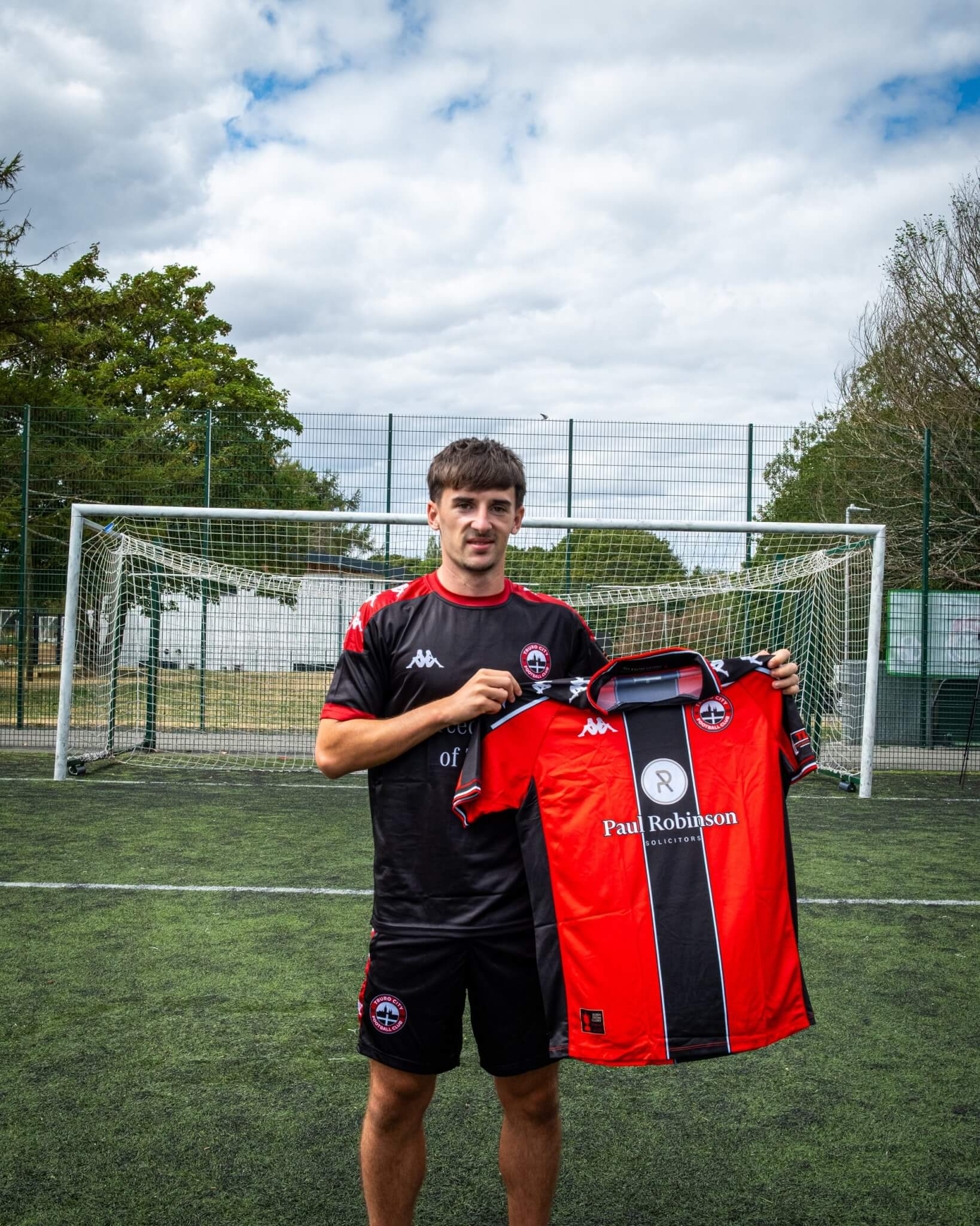 Tom Dean holds the Truro City home shirt after completing his loan move