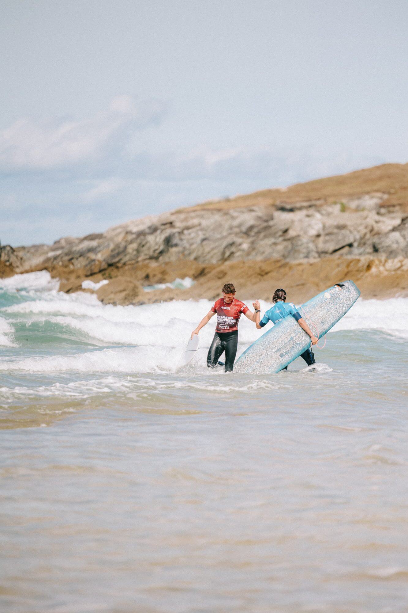 Two Boardmasters Open competitors shake hands in the shorebreak after their heat at Fistral