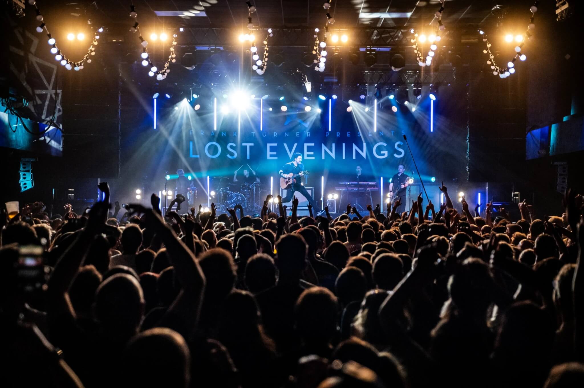 A packed crowd with hands in the air watching Frank Turner and The Sleeping Souls at the Eden Sessions