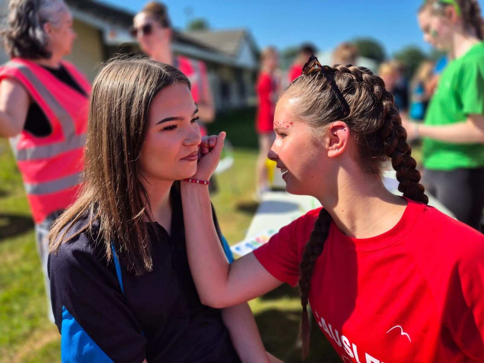A student has her face painted to raise money for Cancer Research UK at Launceston College sports day