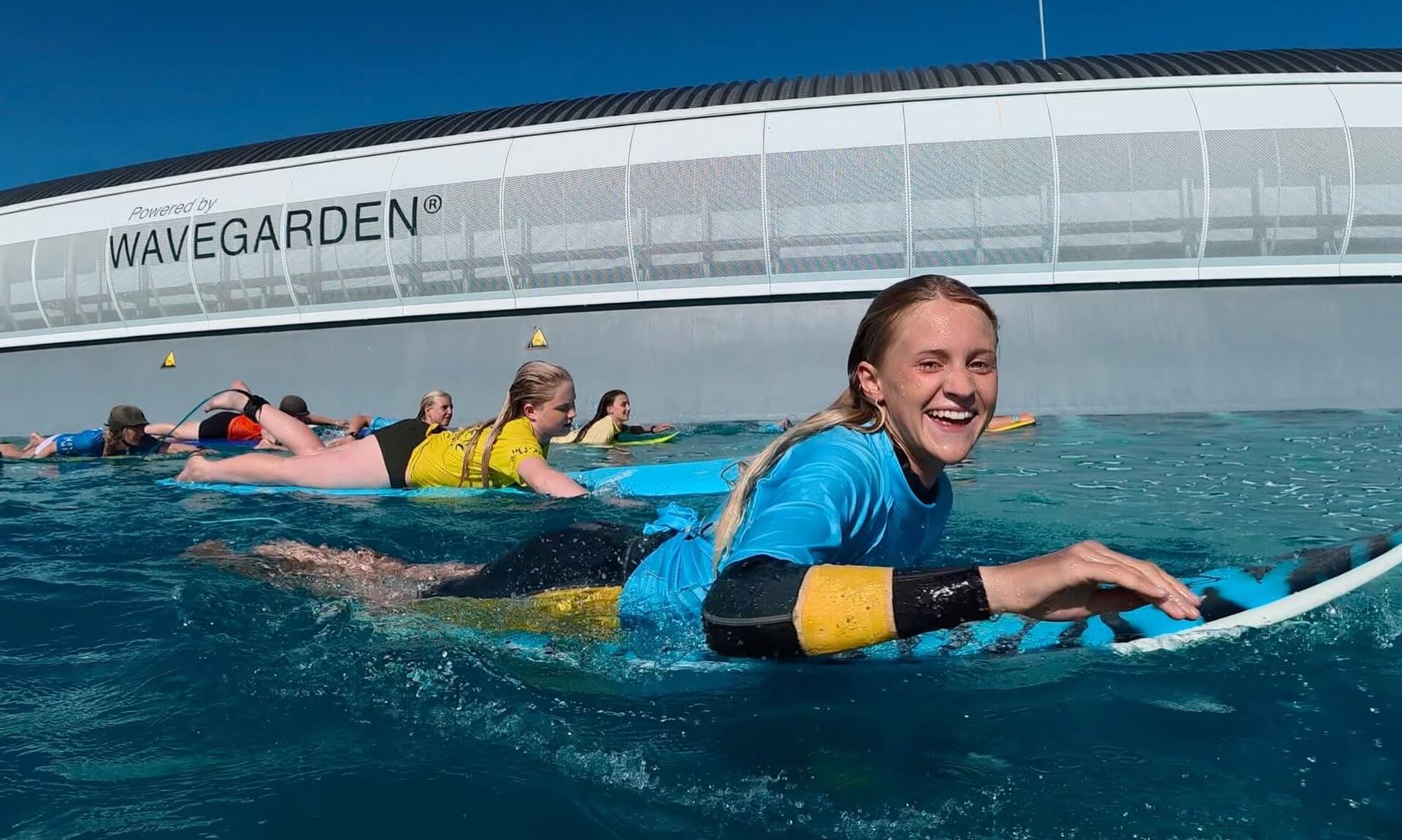 Bella Lewellyn smiling in the water during surf training
