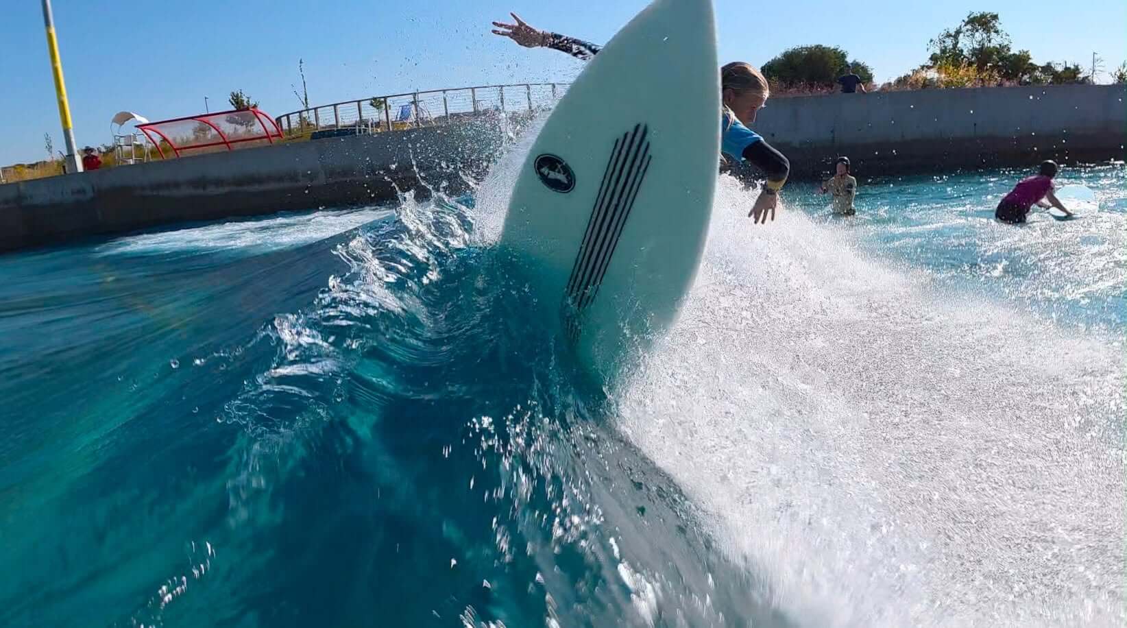 Junior surfers training together in a wave pool