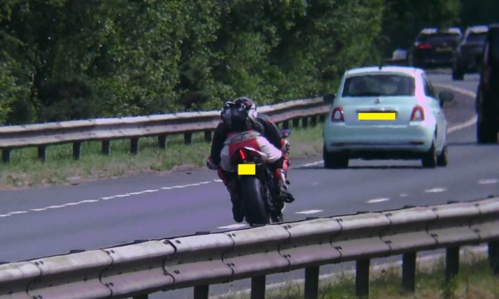 Motorcyclist on the A30 near Bodmin alongside a light blue Fiat 500