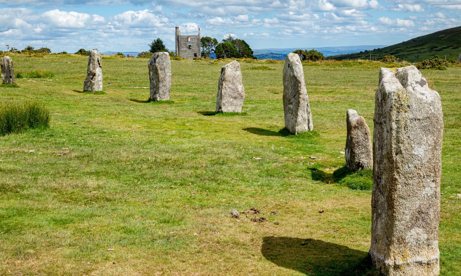 The Hurlers stone circles at Minions on Bodmin Moor, with a ruined mine engine house behind