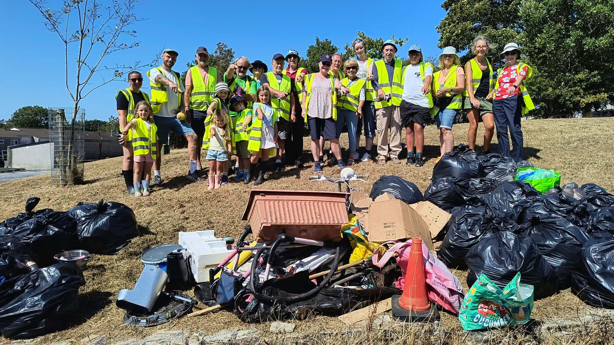 The Bodmin Tidy it Team of 23 volunteers with their haul of rubbish, recycling and junk
