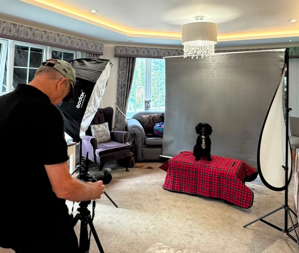 A photographer setting up a portrait shot of a dog on a photography day at Falmouth Court Care Home