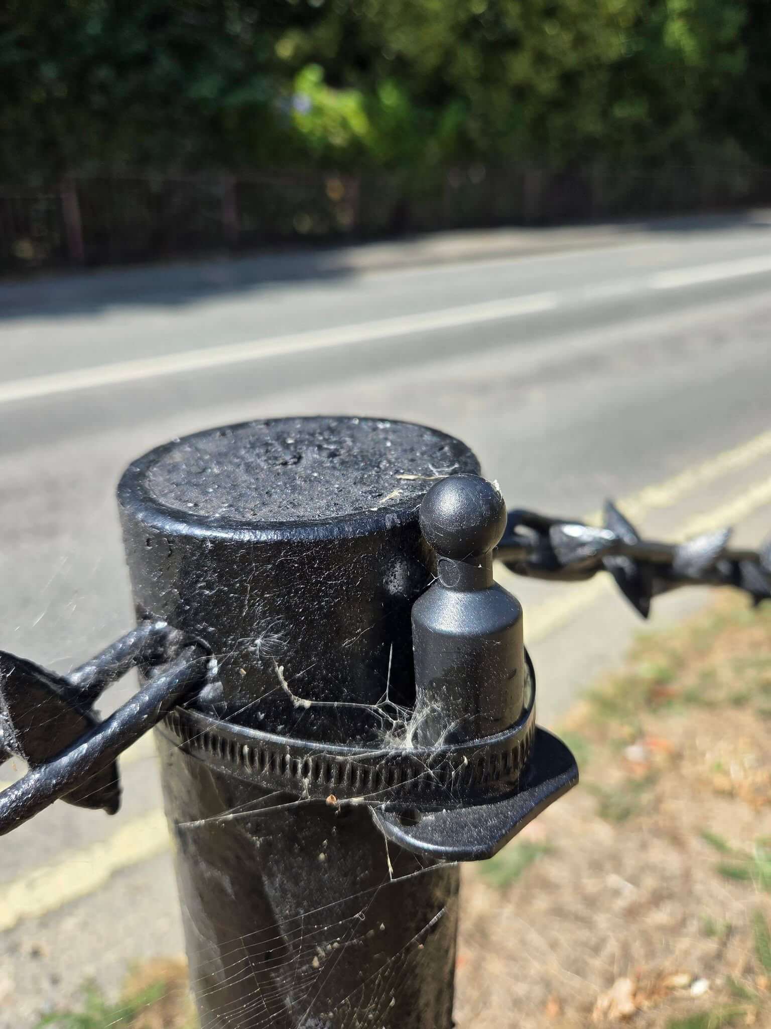 An empty bracket where a solar light has been removed from a bollard in Mevagissey's Valley Road garden area