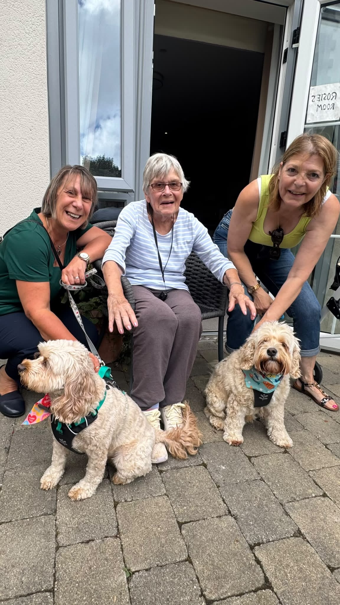 Two dogs with staff and a resident at Falmouth Court Care Home's photography day