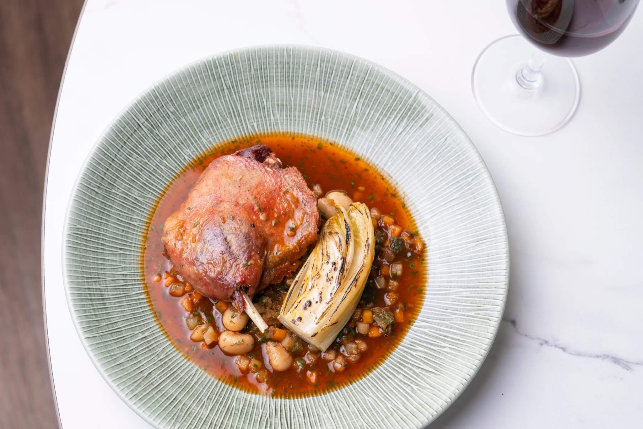 Confit duck with butter bean cassoulet and braised chicory