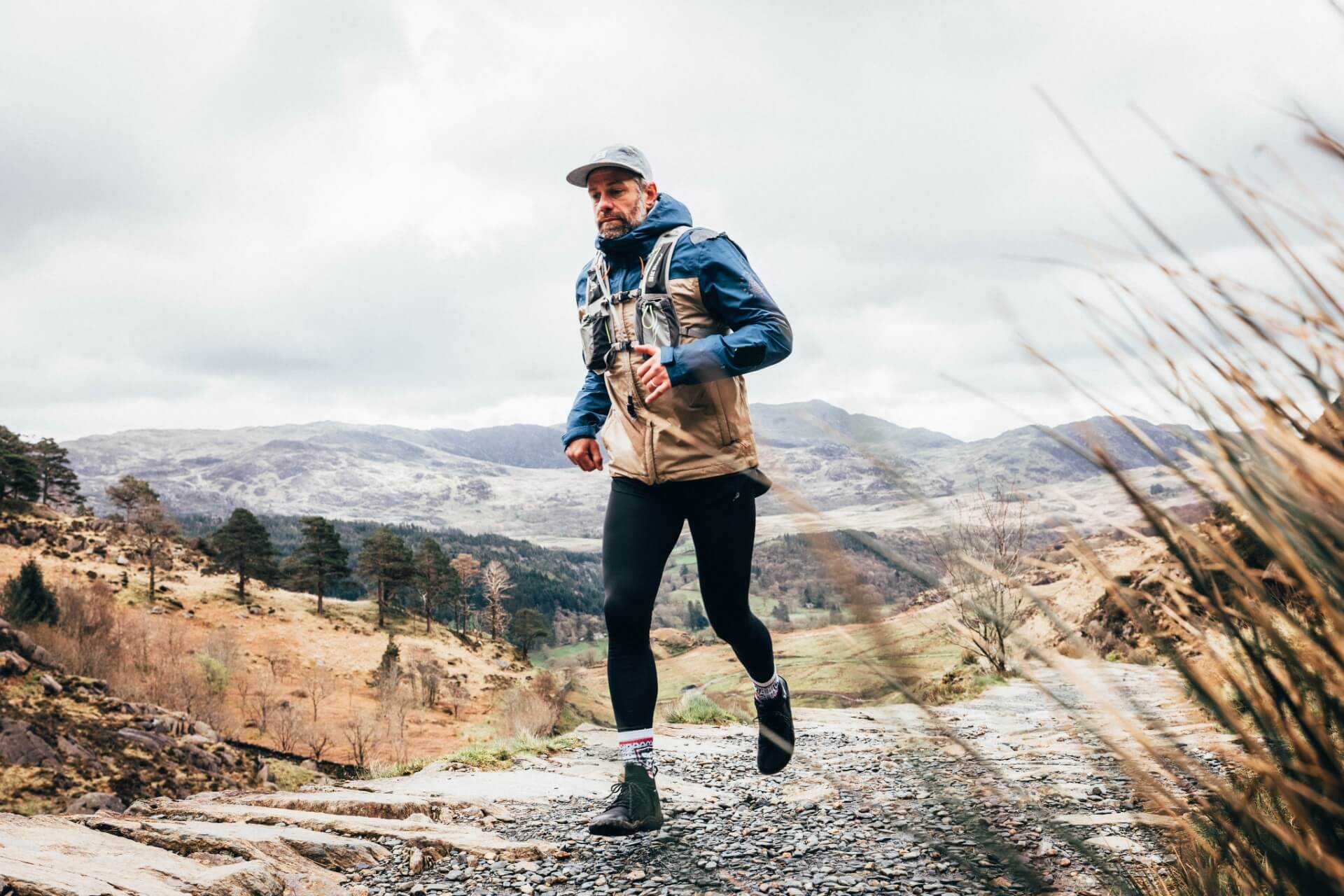David 'Jacko' Jackson running on a mountain trail in a jacket