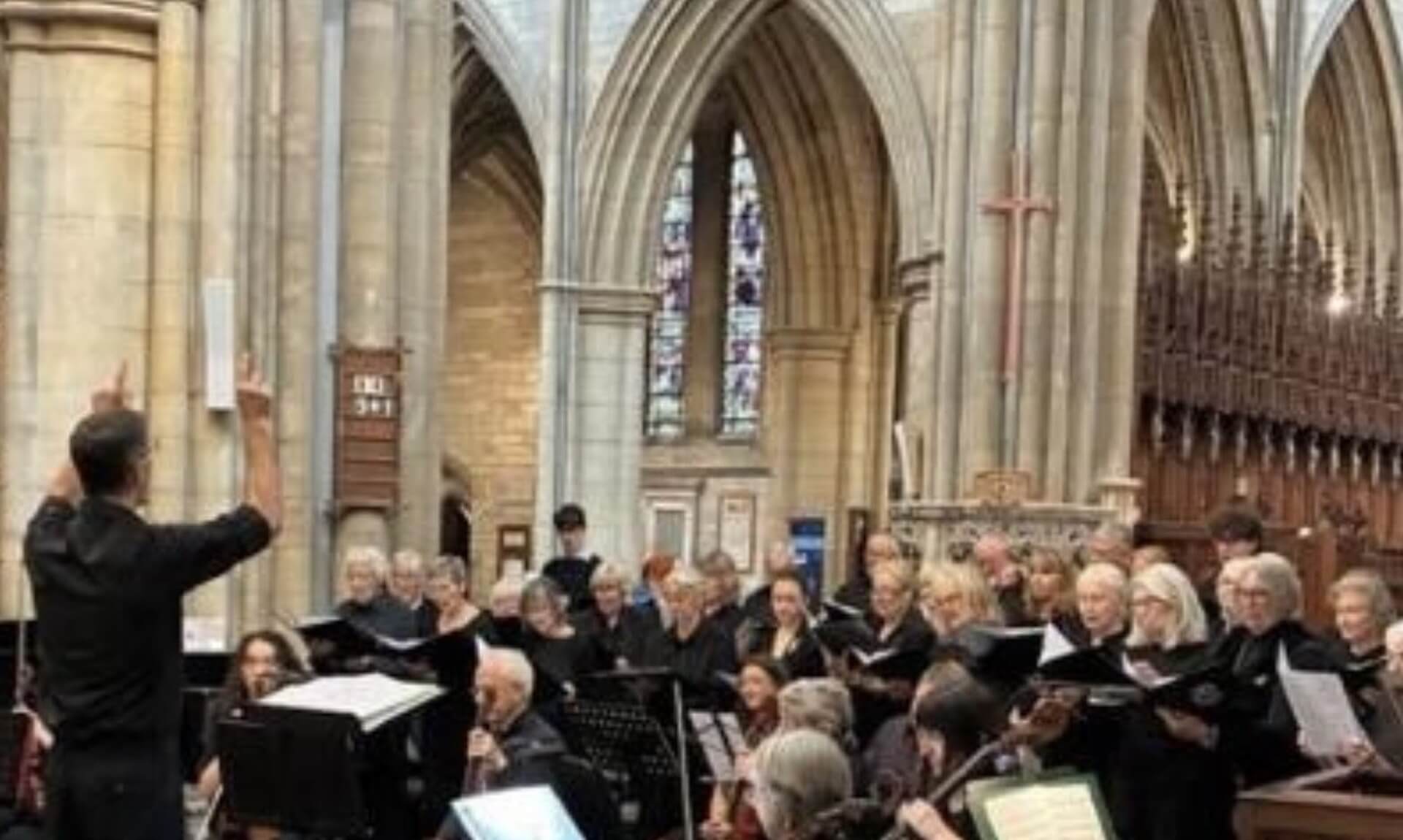 Martin Palmer conducts a choir and orchestra inside Truro Cathedral