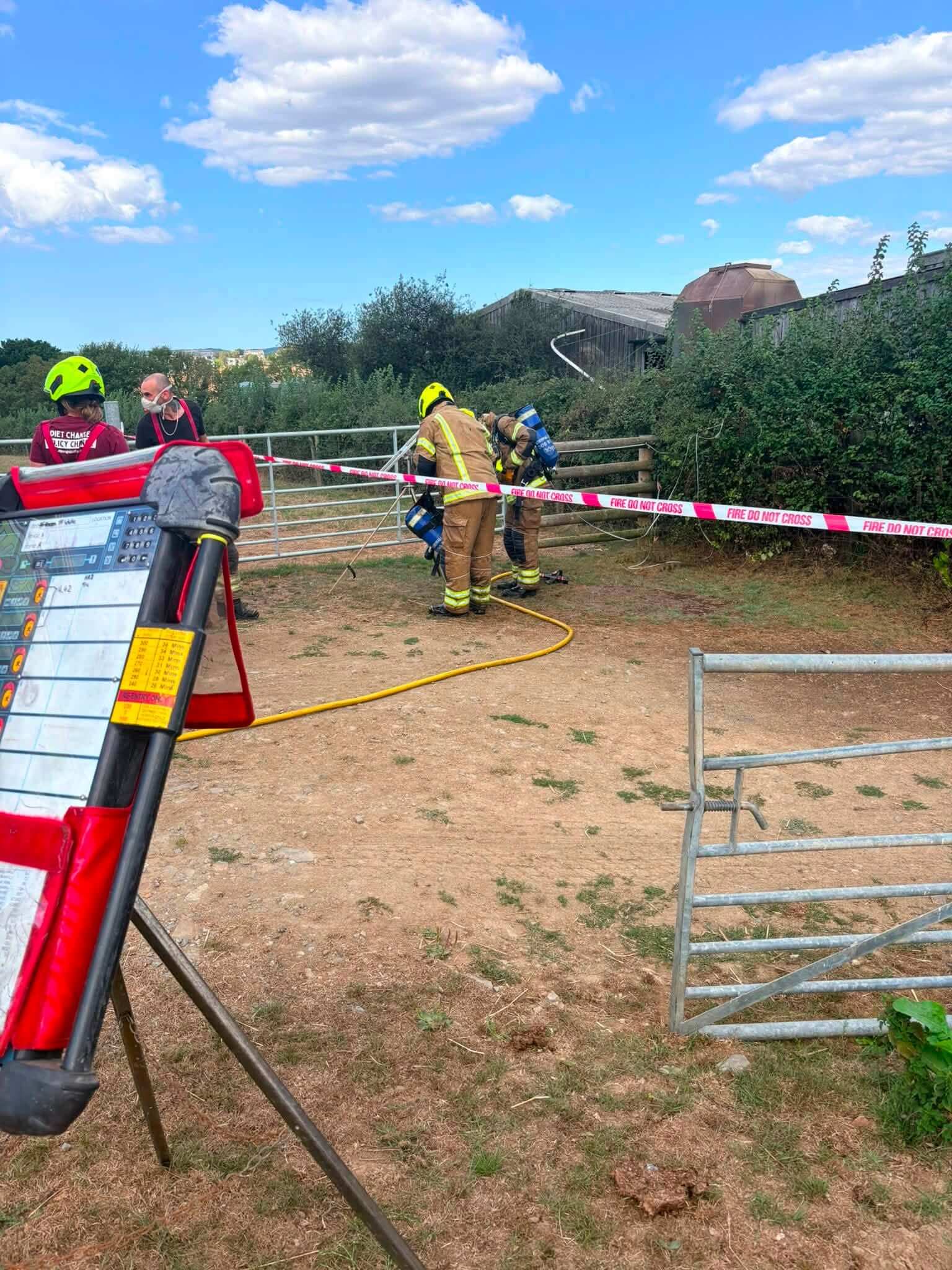 Firefighters at the fire scene near a decontamination cordon