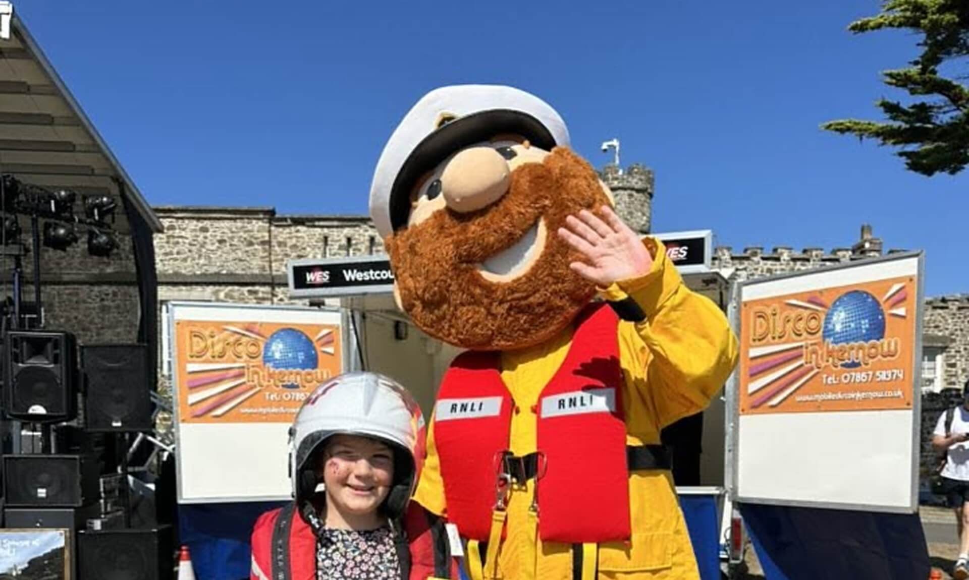 The Bude RNLI lifeboat mascot with a young visitor at a previous Bude Lifeboat Day