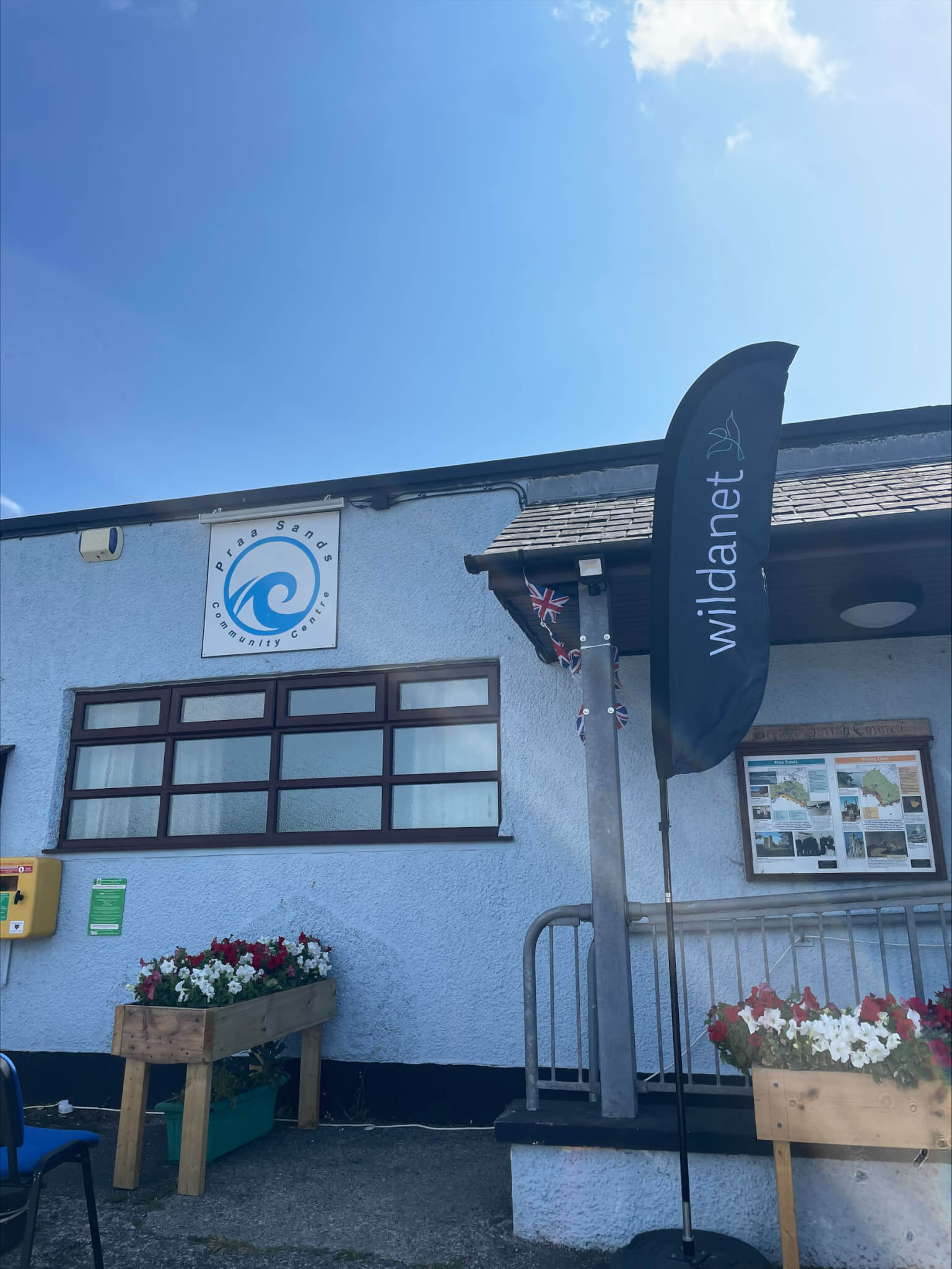 The exterior of Praa Sands Community Centre with a Wildanet flag