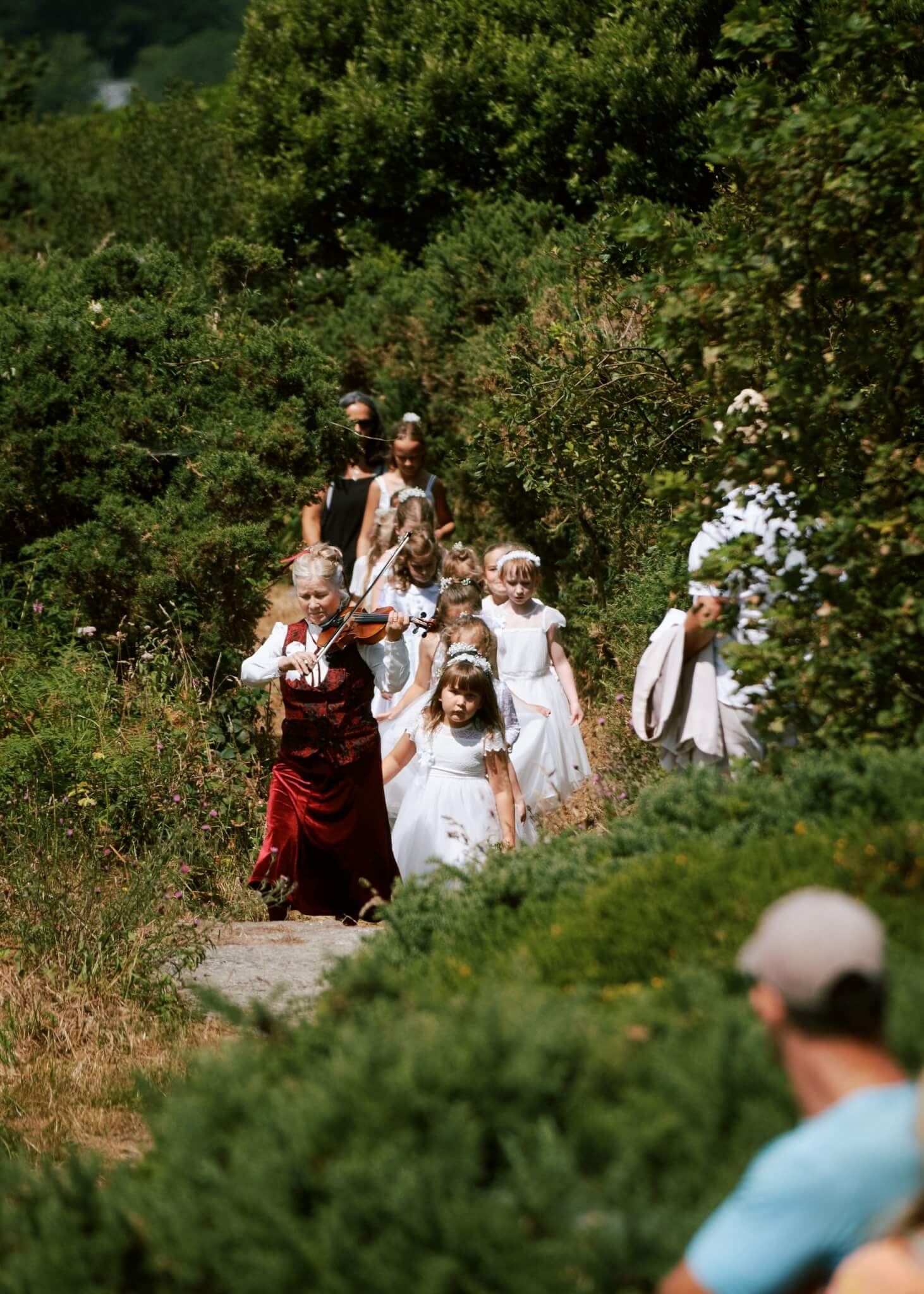 The fiddler leads the maids down a gorse-lined path on Worvas Hill