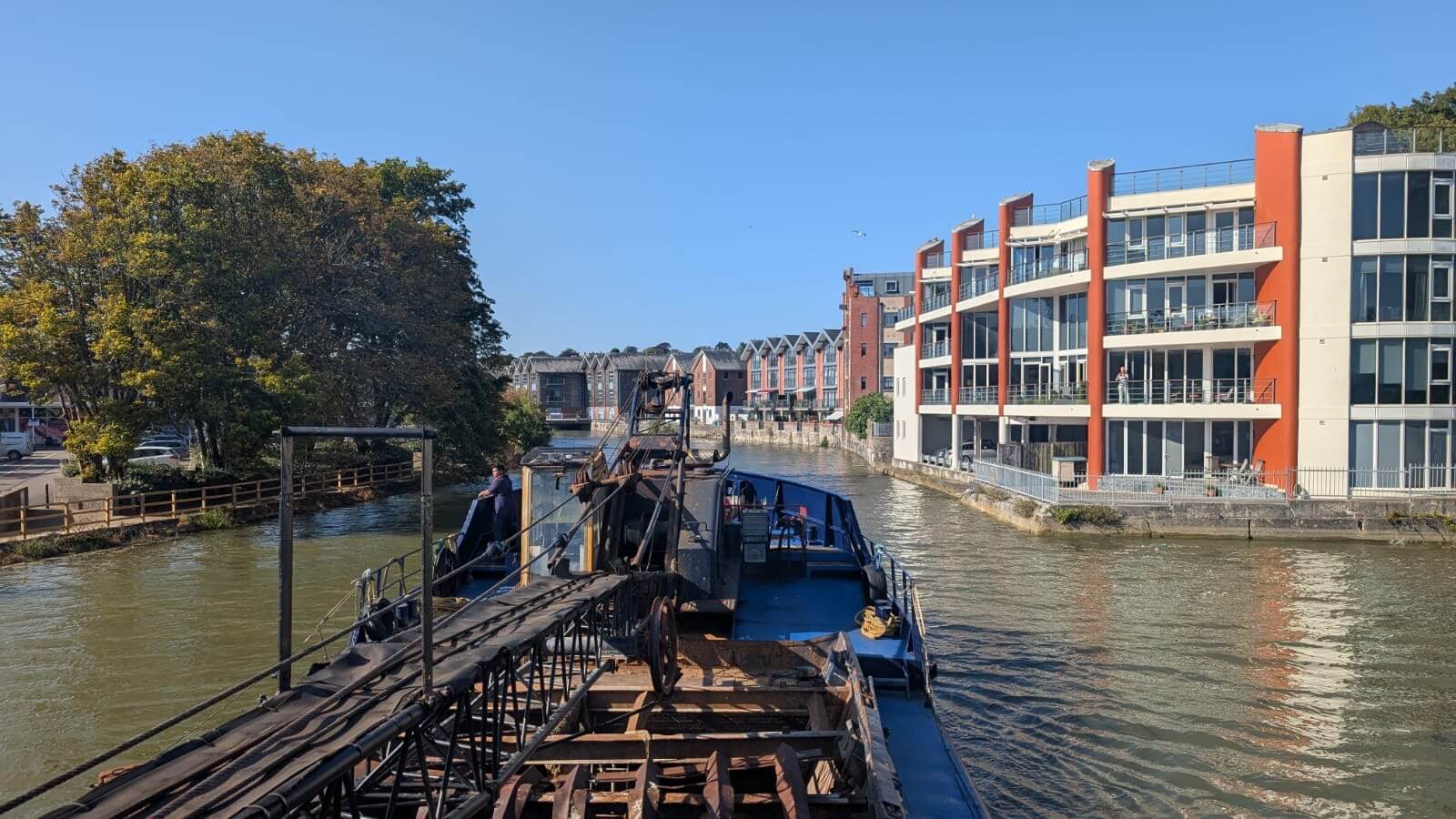 The Mannin passing waterside apartments on the Truro River