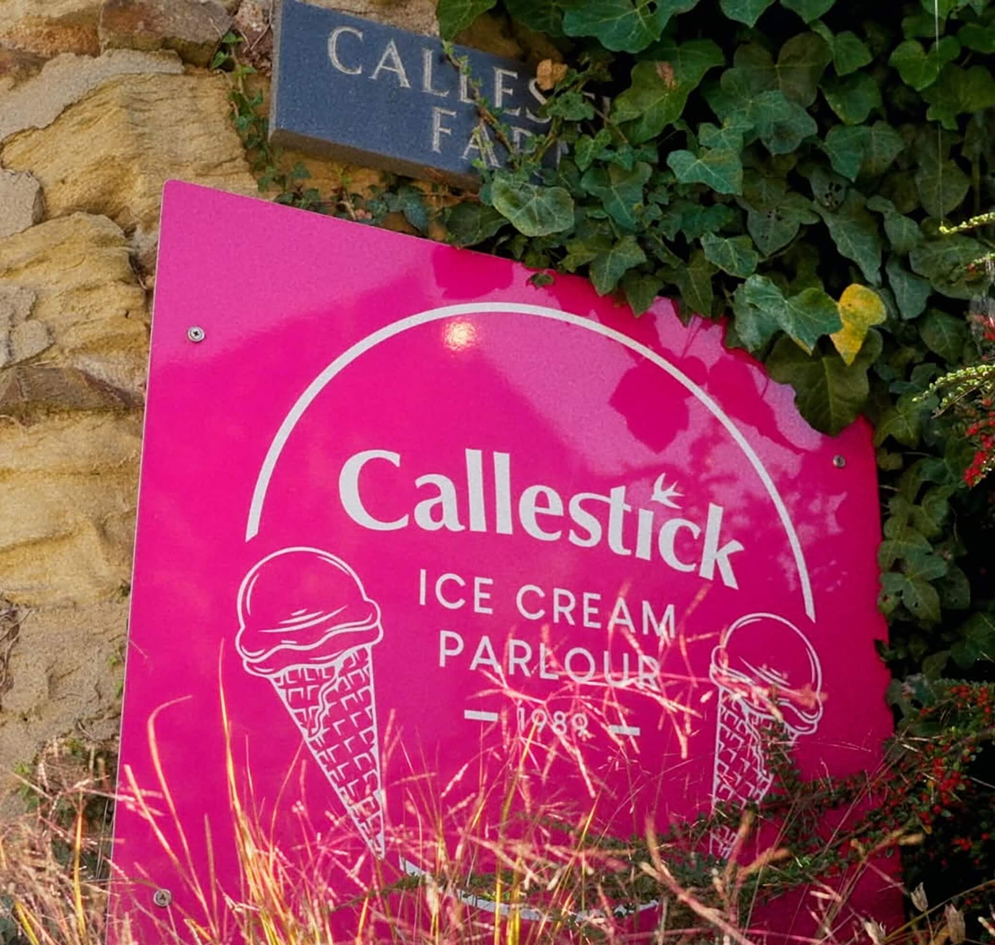 Callestick Ice Cream Parlour sign beside the stone Callestick Farm plaque