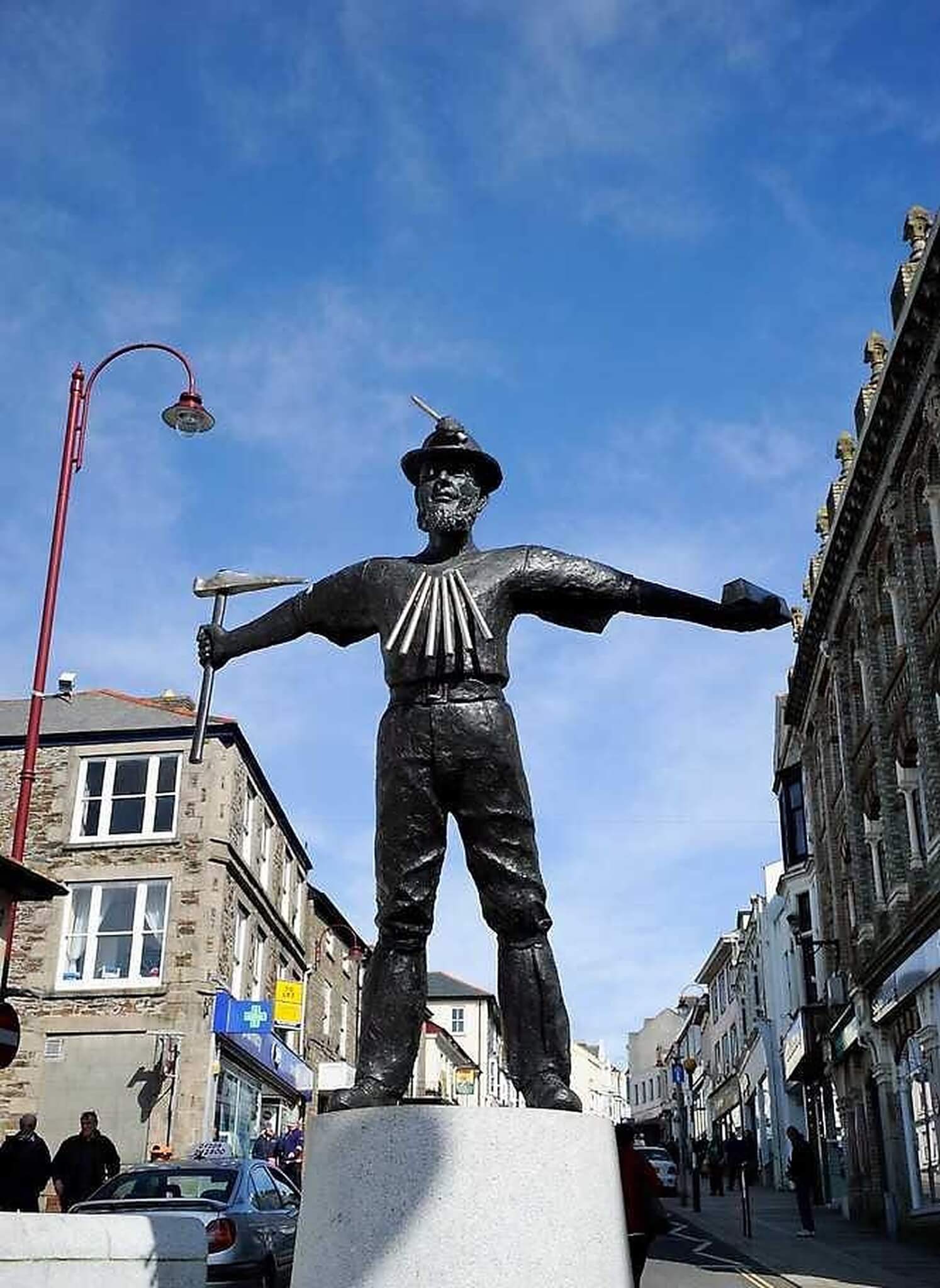 The miner statue in Camborne town centre under a blue sky
