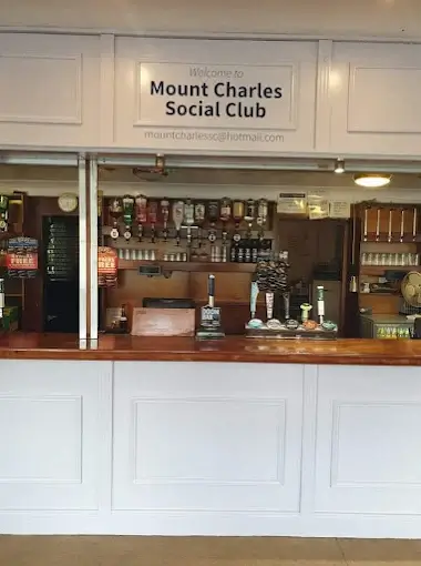 The bar and Welcome to Mount Charles Social Club sign inside the club in St Austell