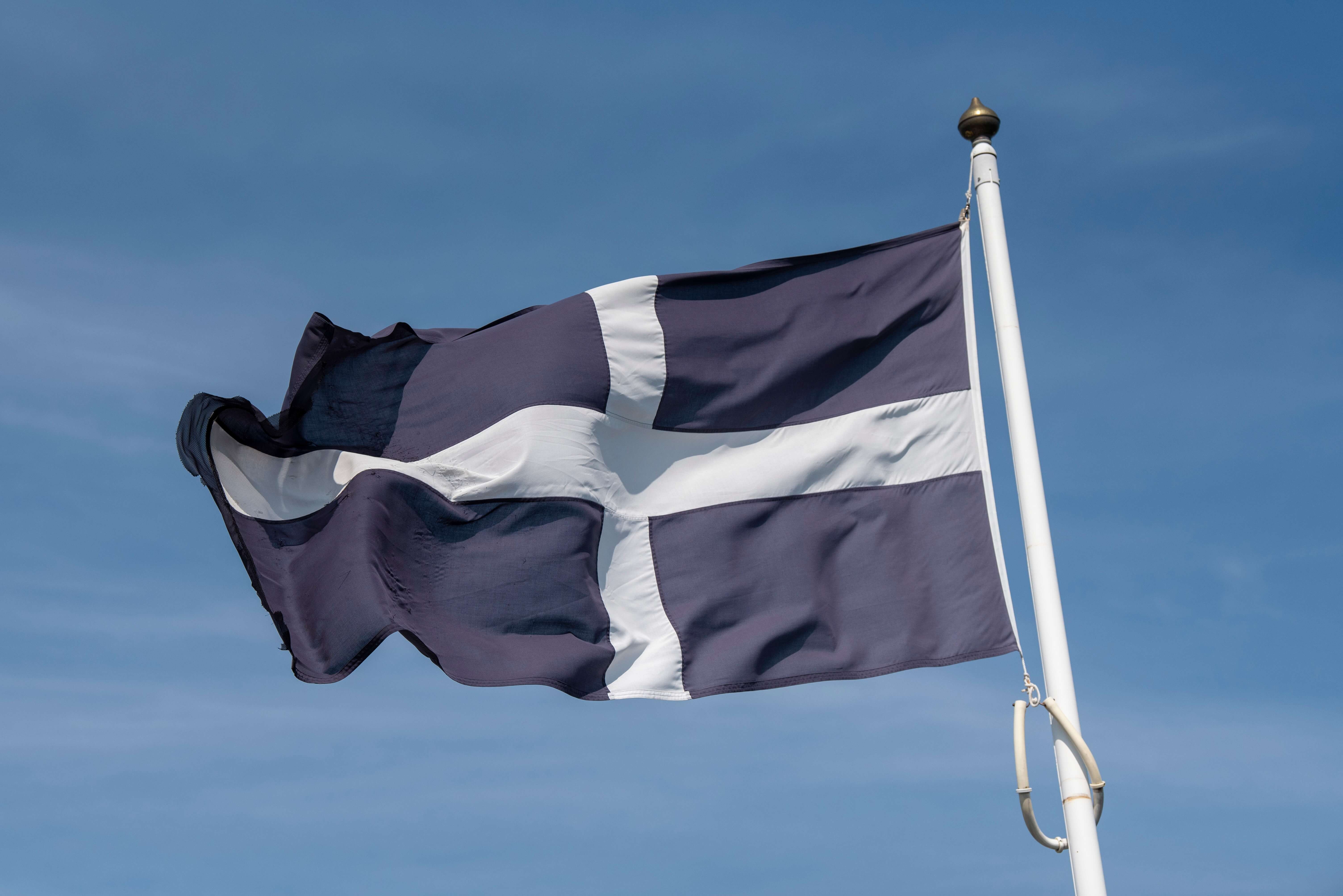 The St Piran's flag flying against a blue sky