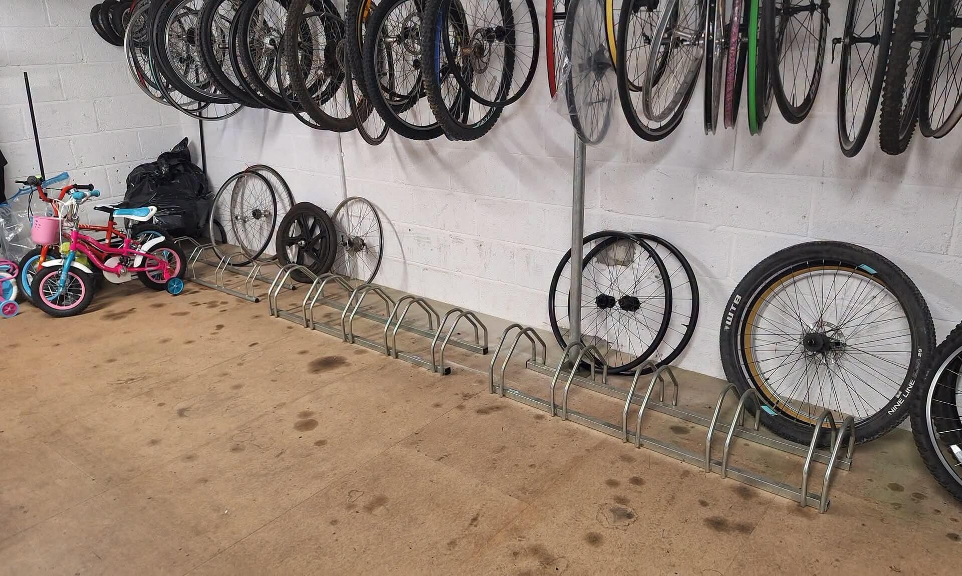 Bicycle wheels and children's bikes stored at a Cornwall Bicycle Project workshop