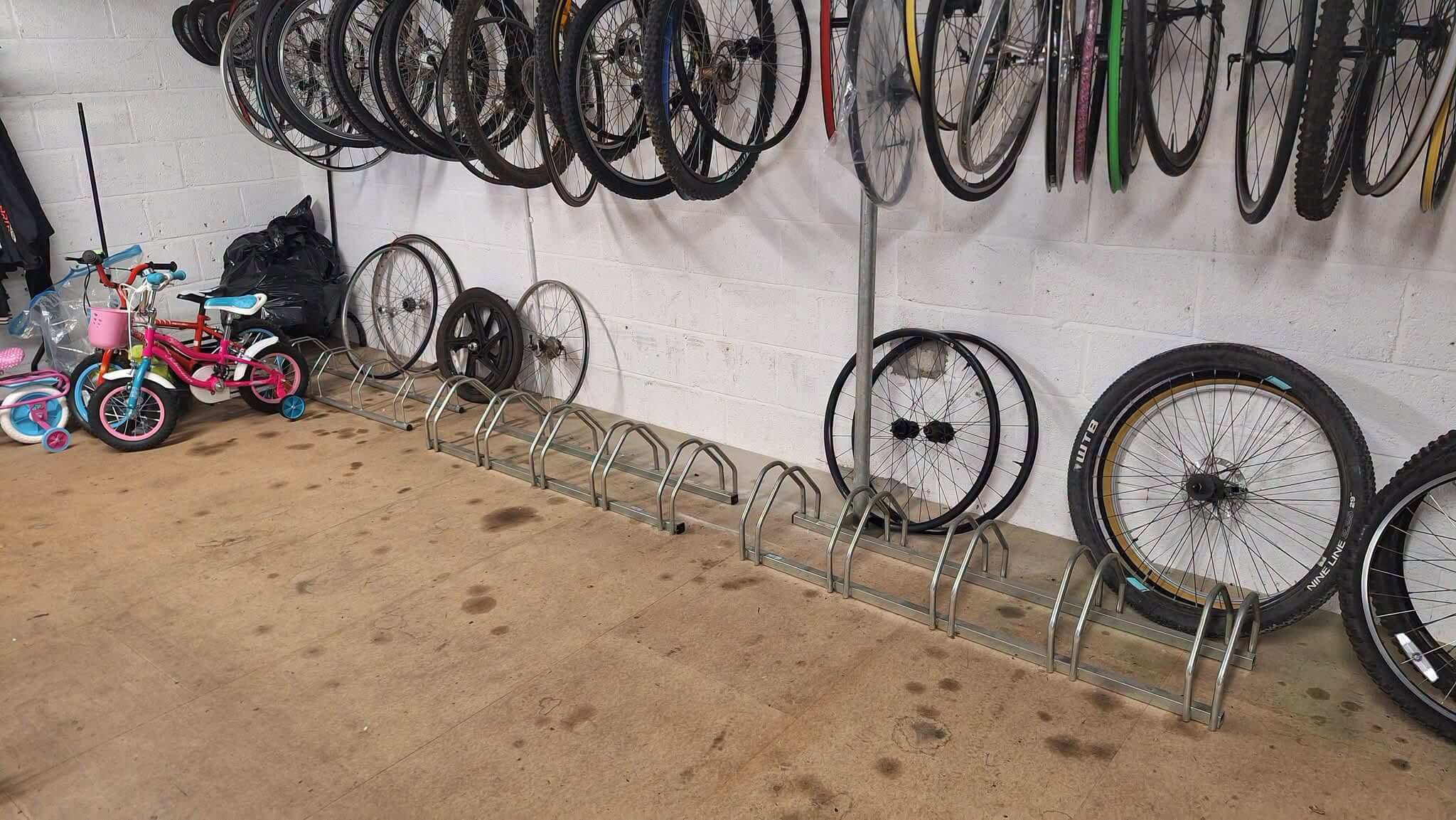 Bicycle wheels and children's bikes stored at a Cornwall Bicycle Project workshop