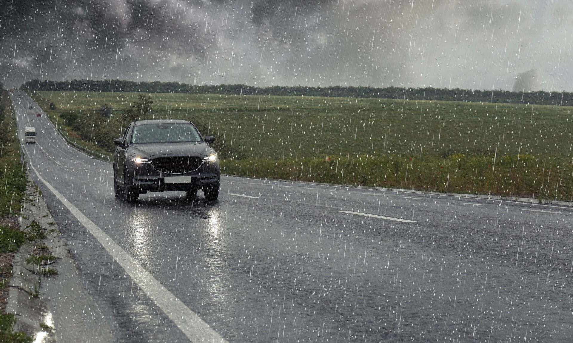 Car driving through heavy rain on a Cornwall road